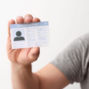 Person holding a driver's license up. 