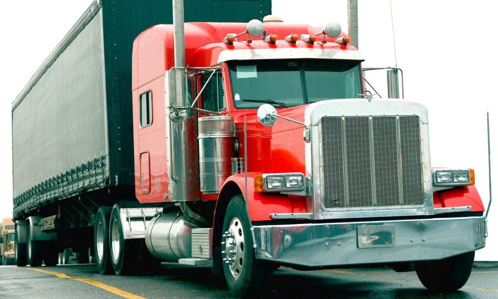 A red semi truck on the road
